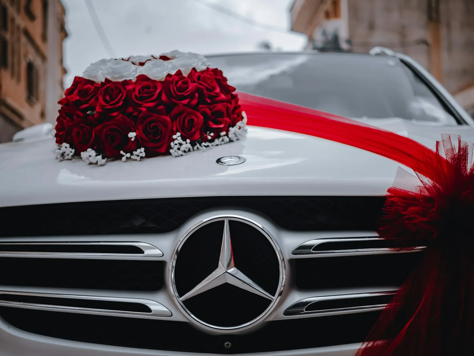 a mercedes car with a bouquet of roses on the hood