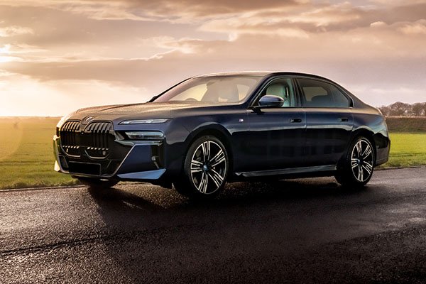 BMW 7 Series on a countryside road, effortlessly blending luxury and performance for a smooth ride through London’s streets.