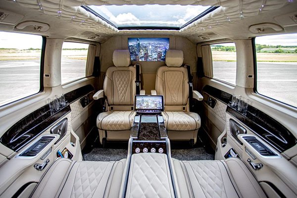 Luxurious Mercedes-Benz Jet Class interior with leather seats, reclining comfort, and built-in tables for business or relaxation while traveling in London.